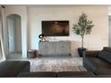 A stylish living room with modern decor, a large television, and comfortable seating at 1567 Lake Reserve Dr, Deland, FL 32724
