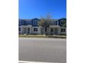 Charming townhomes with white exteriors, blue trim, and well-maintained landscaping at 6917 Five Oaks Dr, St Cloud, FL 34773