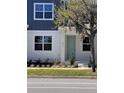 Close up of a townhome entrance featuring a stylish light blue front door at 6917 Five Oaks Dr, St Cloud, FL 34773