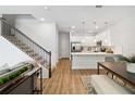 Bright living space features stairs, open to the kitchen, and wood-style flooring at 3317 Grande Heron Dr, St Cloud, FL 34773