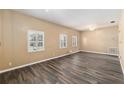 Bright living room featuring light walls, wood-look floors, and white windows that bring in natural light at 3200 Se 34Th St, Ocala, FL 34471