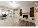 Open-concept room with fireplace, ceiling fan and grey cabinets offering plenty of space for dining and entertaining at 3200 Se 34Th St, Ocala, FL 34471