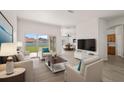 Bright living room featuring wood floors, modern furniture, and large glass doors at 3601 Weatherfield Dr, Kissimmee, FL 34746