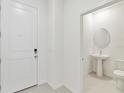 Inviting entryway with neutral tones, a white front door, and a convenient powder room at 5244 Luisa Ct, St Cloud, FL 34771