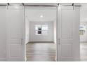 Bright room entrance with stylish barn doors showcasing the natural light and flooring at 9432 Emerald Berry Dr, Winter Garden, FL 34787