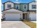 Inviting townhomes with neutral colors, two car garages, and brick paver driveways at 2465 Magnolia Reserve Rd, Ocoee, FL 34761