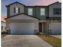 Inviting townhomes with neutral colors, two car garages, and brick paver driveways at 2465 Magnolia Reserve Rd, Ocoee, FL 34761