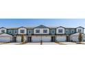 A row of new townhomes with a shared driveway in a well-maintained community with modern architecture at 2473 Magnolia Reserve Rd, Ocoee, FL 34761