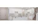 Bright kitchen with white cabinets, granite countertops, a center island, and stainless steel appliances at 5289 Luisa Ct, St Cloud, FL 34771