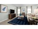 Comfortable living room featuring modern decor, a plush sofa, and a large TV at 1561 Texas Ave, Sumterville, FL 33585