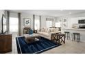 Bright living room with large windows, stylish furniture, and an open floor plan at 1561 Texas Ave, Sumterville, FL 33585