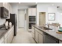 Well-appointed kitchen with stainless steel appliances, ample cabinet space, and sleek granite countertops at 5012 Bear Lake Loop, Deland, FL 32724