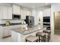 Spacious kitchen with granite countertops, stainless steel appliances, and a large island with seating at 5012 Bear Lake Loop, Deland, FL 32724