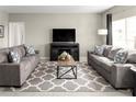 Spacious living room with matching sofas, decorative pillows and a gray rug at 1365 Laramie Way, Haines City, FL 33844