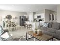 Open-concept living area with a kitchen island, dining table, and comfortable seating at 1365 Laramie Way, Haines City, FL 33844