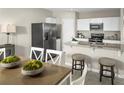 Bright kitchen featuring stainless steel appliances, granite countertops, and an eat-in dining area at 1546 Landon Ln, Haines City, FL 33844