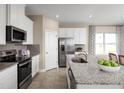 Modern kitchen featuring stainless steel appliances and a large island with granite countertops at 5035 Bear Lake Loop, Deland, FL 32724