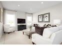 Spacious living room filled with natural light, featuring elegant sofas, contemporary decor, and a comfortable seating arrangement at 11030 Nellie Crossing Cir, Clermont, FL 34711