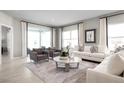 Comfortable living room showcasing neutral tones, stylish seating, and natural light at 3034 Cayey Way, Clermont, FL 34711