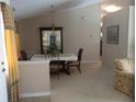 Inviting dining room featuring a chandelier, neutral paint, carpet, and natural light at 3850 Plantation Blvd, Leesburg, FL 34748