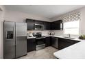 Stylish kitchen with stainless steel appliances, black cabinetry, and bright countertops for a modern look at 415 Harvard Ct, Dundee, FL 33838