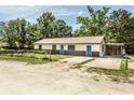 Charming single-story home featuring a metal roof and ample parking space at 910 Nw 56Th Ave, Ocala, FL 34482