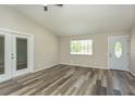 Bright living room with modern flooring, fresh paint, and ample natural light at 910 Nw 56Th Ave, Ocala, FL 34482