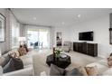 Bright living room with recessed lights, neutral walls, plush sofa, and sliding glass doors at 9836 Pine Mill Ct, Clermont, FL 34711