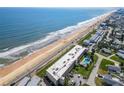 Aerial shot showcases a condo building with pool, near a beach, with ocean view at 2600 Ocean Shore Blvd # 111, Ormond Beach, FL 32176