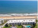 Overhead view of a beachfront condo building complex with a pool and ocean views at 2600 Ocean Shore Blvd # 111, Ormond Beach, FL 32176