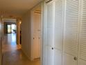 Hallway with neutral tile flooring leading to living area with closet storage at 2600 Ocean Shore Blvd # 111, Ormond Beach, FL 32176