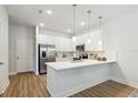 Modern kitchen features white cabinets, stainless steel appliances, and a sleek countertop with pendant lighting at 3321 Grande Heron Dr, St Cloud, FL 34773