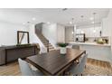 Open concept living space boasts modern finishes, including a staircase with iron railing and hardwood floors at 3321 Grande Heron Dr, St Cloud, FL 34773