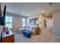Comfortable living room with a sectional sofa, stylish decor, and a view into the hallway at 654 Reader Ln, Debary, FL 32713
