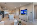 Bright, open-concept living area featuring tile floors, a modern kitchen and stainless steel appliances at 671 Four Leaf Ave, Debary, FL 32713