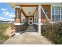 A welcoming, covered front porch with decorative columns and a well-kept entrance at 7355 Se 106Th Pl, Belleview, FL 34420