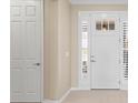 Bright foyer featuring a white front door with sidelights and a neutral color palette at 9262 Sw 102Nd Avenue Rd, Ocala, FL 34481