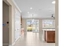 Open concept great room with tile flooring, modern lighting, and sliding glass doors at 9262 Sw 102Nd Avenue Rd, Ocala, FL 34481