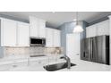 Well-equipped kitchen featuring sleek countertops, stainless steel appliances, and ample cabinet space for storage at 1310 Whispering Ln, Minneola, FL 34715