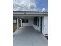 A covered carport provides convenient parking next to the home's entrance at 232 Thomas Ave, Frostproof, FL 33843