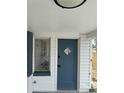 The home's front door with decorative window is flanked by a glass block window at 232 Thomas Ave, Frostproof, FL 33843