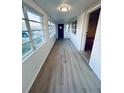 Bright sunroom with durable flooring and multiple windows offering ample sunlight at 232 Thomas Ave, Frostproof, FL 33843