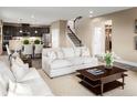 Open-concept living space connecting kitchen, dining area, and staircase with modern furniture at 3758 Voyageurs Ct, Apopka, FL 32712