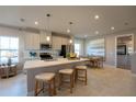 Open-concept kitchen with a large island, stainless appliances, and adjacent dining area perfect for entertaining at 674 Four Leaf Ave, Debary, FL 32713