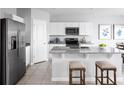 Modern kitchen boasts stainless steel appliances, granite countertops, and a spacious center island with breakfast bar at 1381 Laramie Way, Haines City, FL 33844