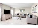 Comfortable living room with neutral tones, plush sofas, accent tables and decor at 1385 Laramie Way, Haines City, FL 33844