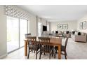 Open floor plan with dining area, seamlessly connected to the living room, and sliding glass doors at 2146 Tennessee St, Sumterville, FL 33585