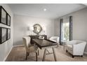 Cozy office with a modern desk, comfortable chairs, and a round mirror above a sideboard at 2146 Tennessee St, Sumterville, FL 33585