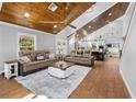 Inviting living room with vaulted wood ceilings, tile floors, and plenty of natural light at 13700 Sw 108Th Ln, Dunnellon, FL 34432