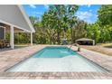 Beautiful pool with a water feature and brick surround, perfect for relaxation and outdoor enjoyment at 13700 Sw 108Th Ln, Dunnellon, FL 34432